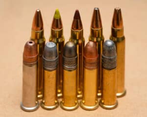 22 LR ammo cartridges stood upright in front of 17 HMR ammo catridges