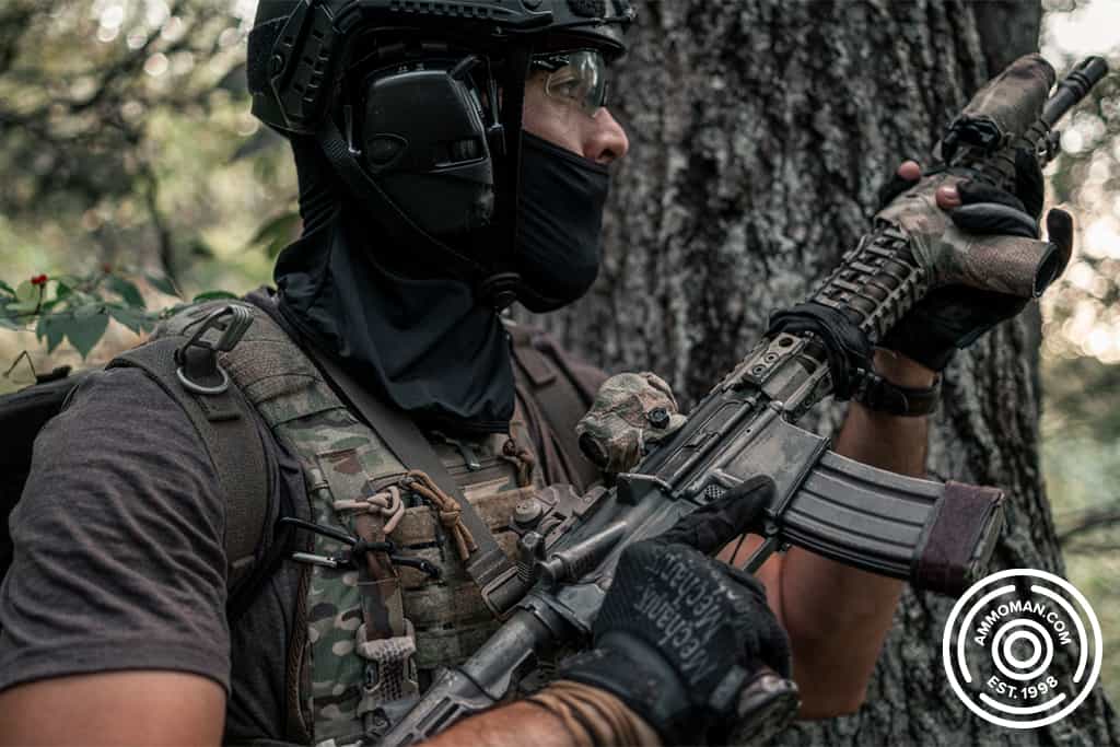 man in mask holding a painted rifle