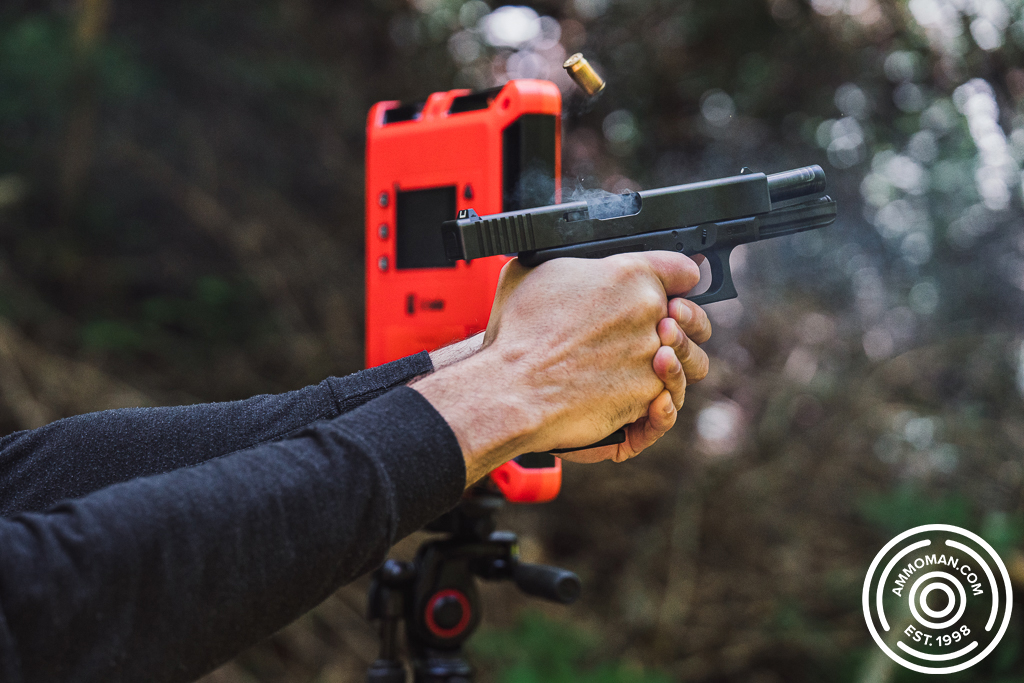 Shooting a pistol with a chronograph to measure velocity at the range