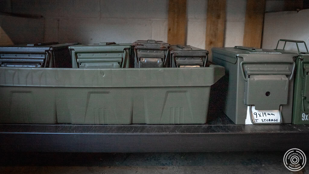 Ammunition cans sitting on a metal shelf in a portable sled.