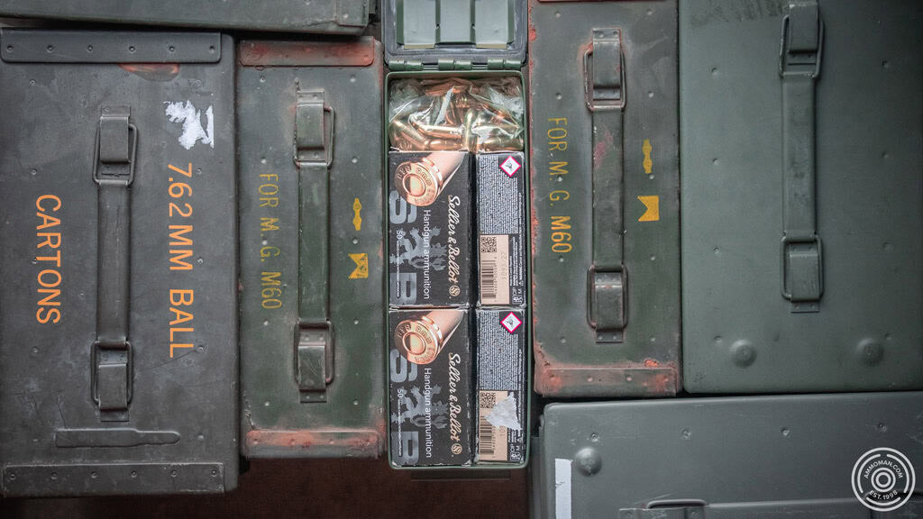 Open ammo can with 9mm in the middle of other ammo cans.