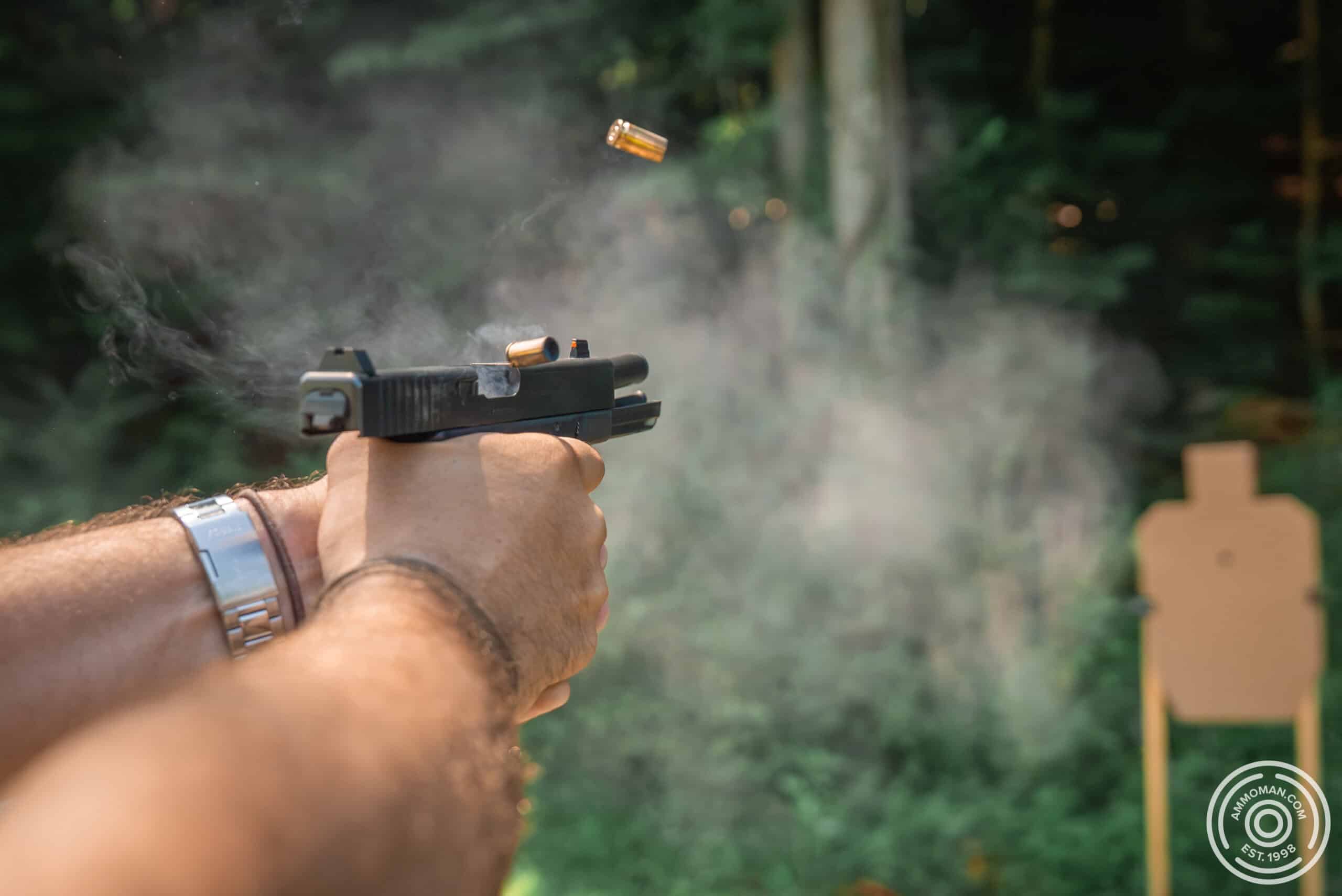 Shooting a "doubles" pistol drill on a USPSA target.