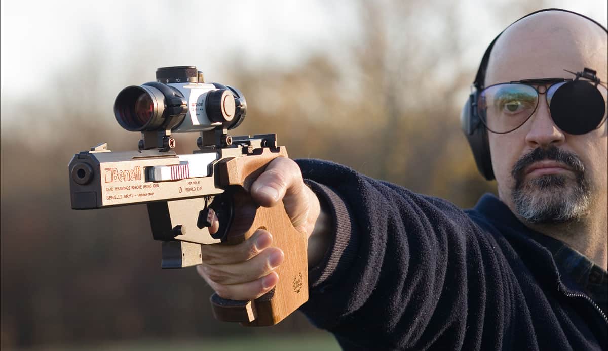 A shooting firing a Benelli pistol with match grade ammo at the range