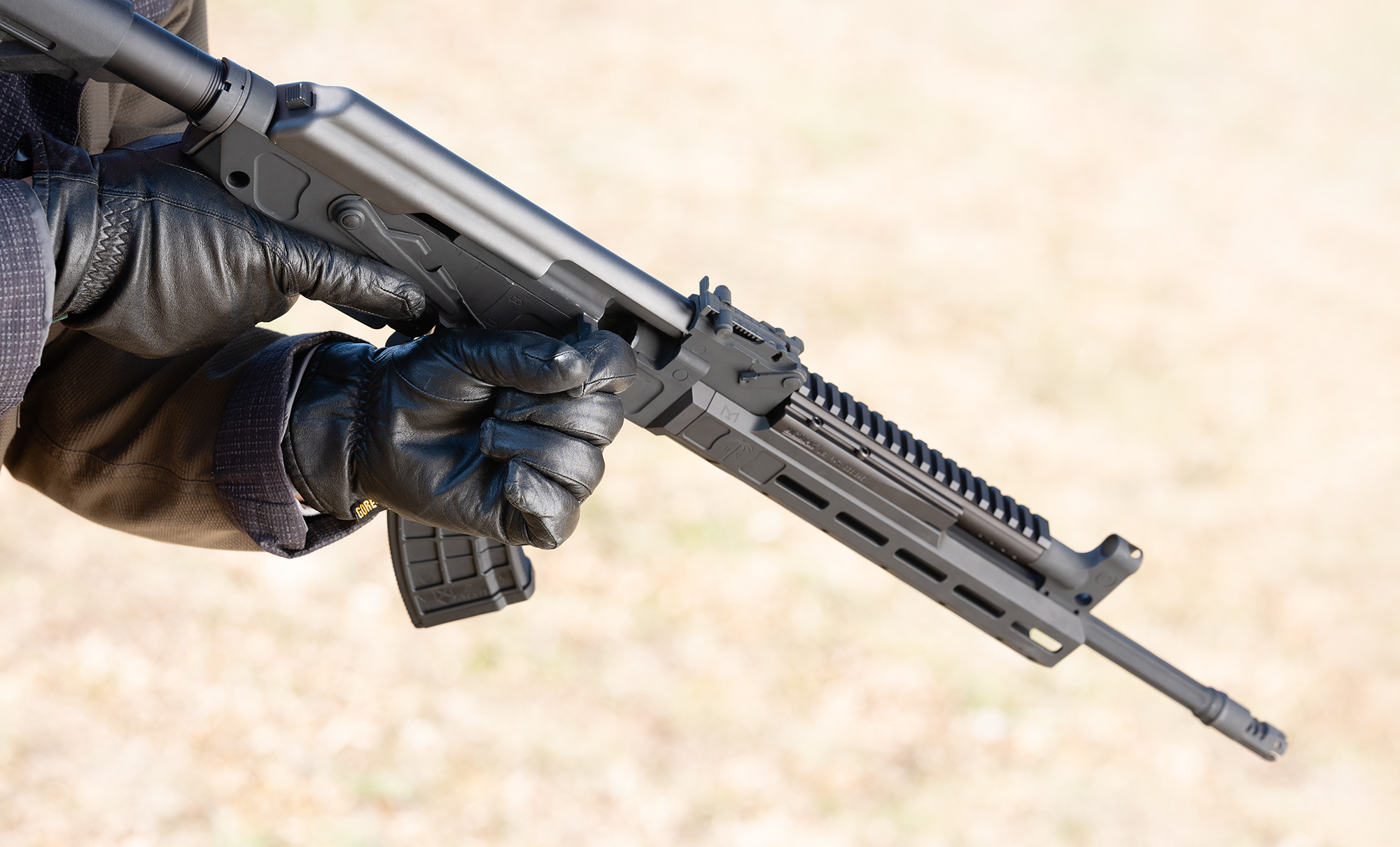 The charging handle of an AK-47 rifle at a shooting range