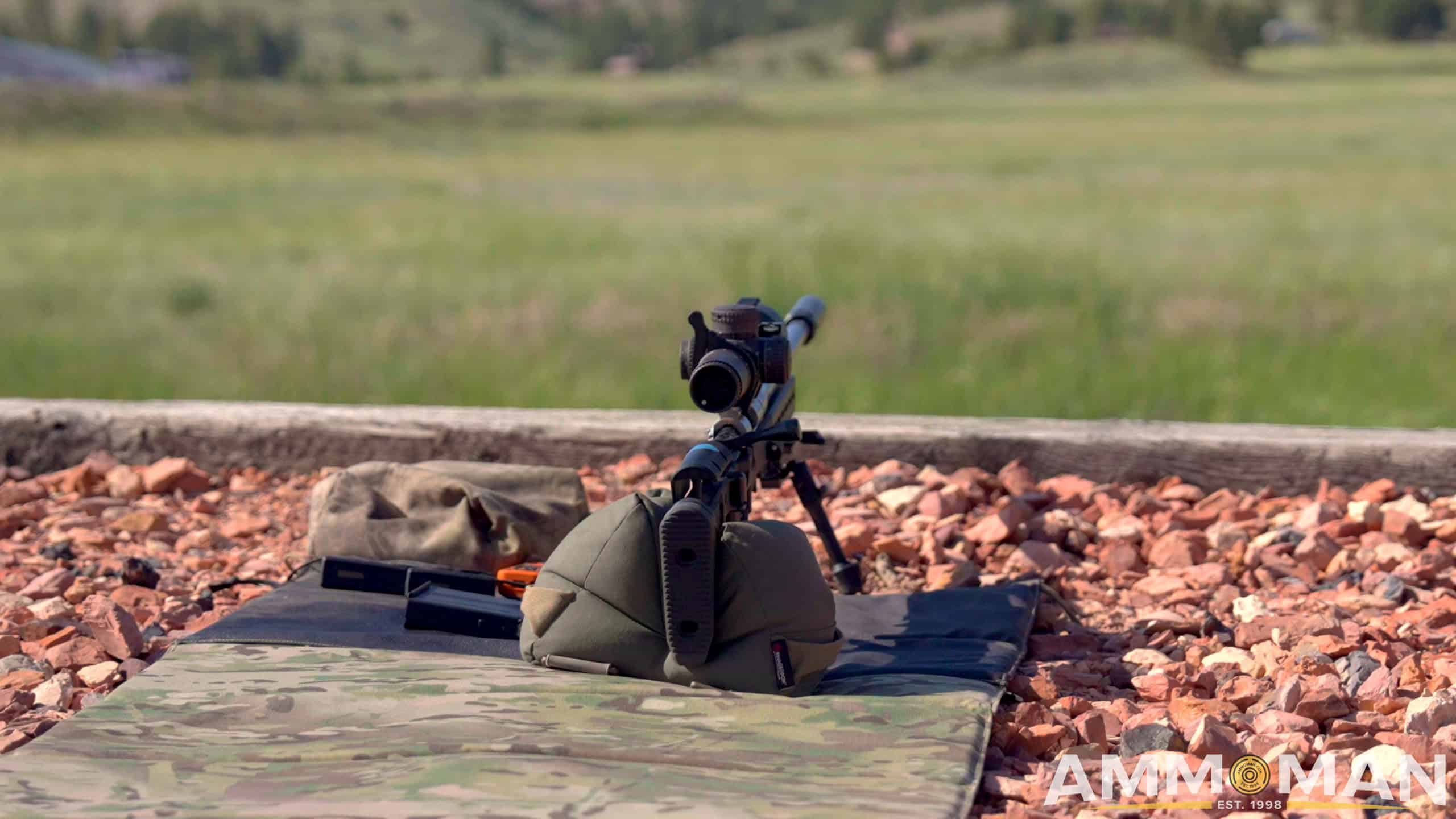 Rifle laying on ground on support bag