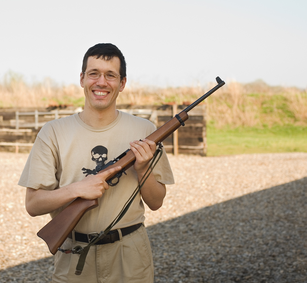 Oleg, the author, holding a 22LR rifle at an Appleseed shooting event.