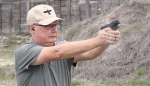 The author firing the Sccy CPX-2 at a shooting range as part of his review