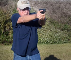 Sights on target while demonstrating a concealed carry draw