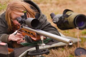 Female rifle shooting firing a gun