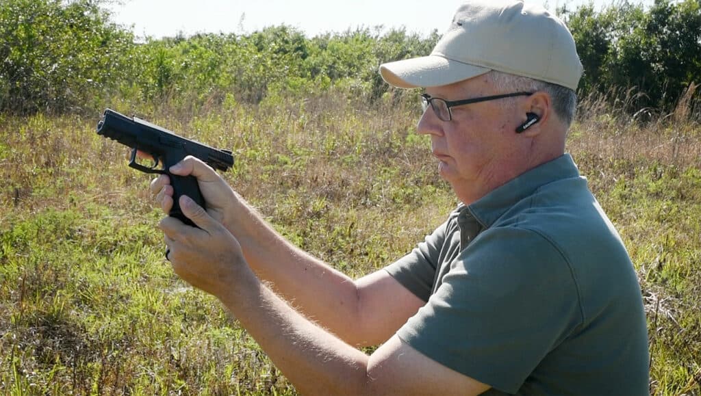 the author removing the magazine from the pistol